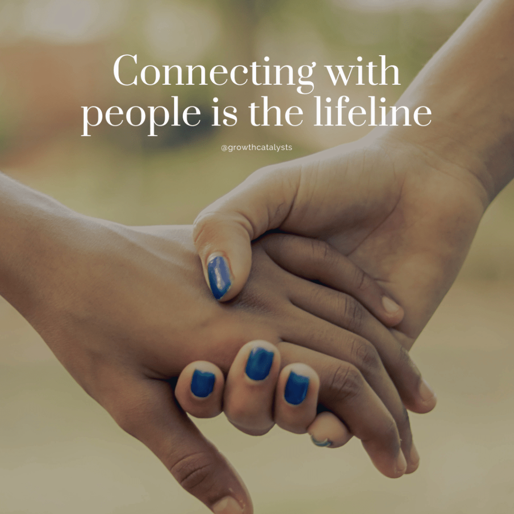 An image of two hands holding each other with the caption, "Connecting with people is the lifeline." and the social media tag @growthcatalysts.